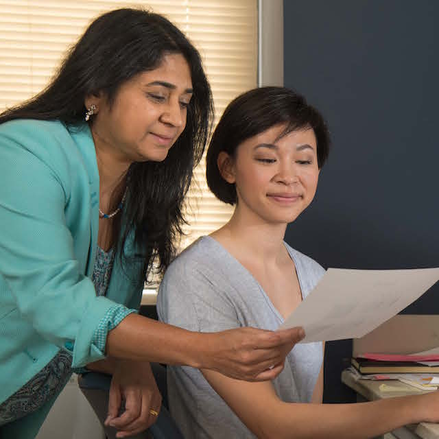 Photo shows doctoral student Donna Dang, left, and Rajini Rao, who directs the Graduate Program in Cellular and Molecular Medicine.